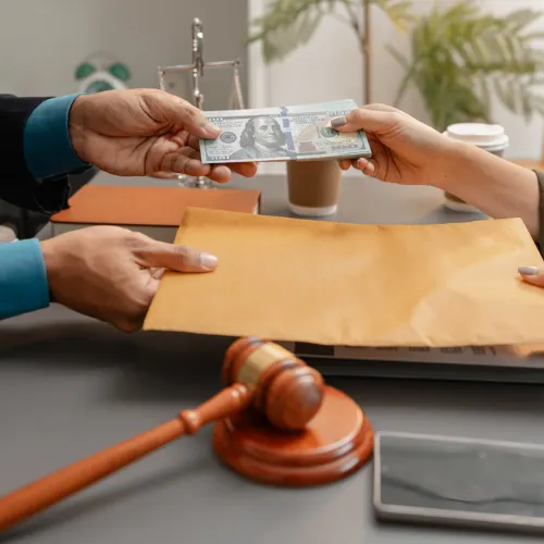 A client hands a stack of cash to a lawyer who holds a brown envelope on the desk, symbolizing bribery, corruption, and unethical financial dealings in a legal or business context.